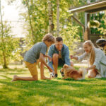 Family,Of,Four,Having,Fun,Playing,With,Cute,Little,Pomeranian