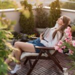 Young,Romantic,Woman,Holding,Book,To,Her,Chest,On,Urban