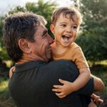 Playful,Grandfather,Spending,Time,With,His,Grandson,In,Park,On